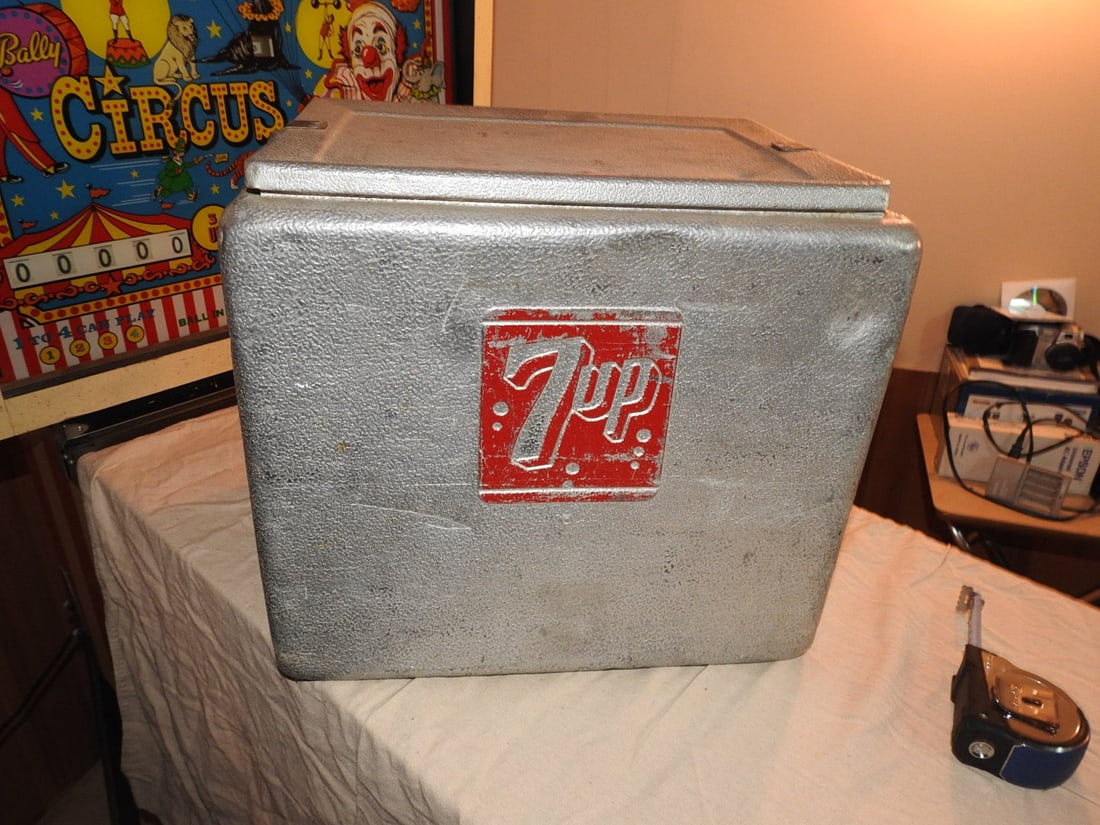 Vintage 7-Up Progress Refrigerator Co. Metal Advertising Cooler: Vintage mid-century 7-Up metal advertising cooler / ice chest by Progress Refrigerator Co., Louisville, Kentucky. Features a textured silver metal body with red 7-Up logo panels, hinged lid, side carr