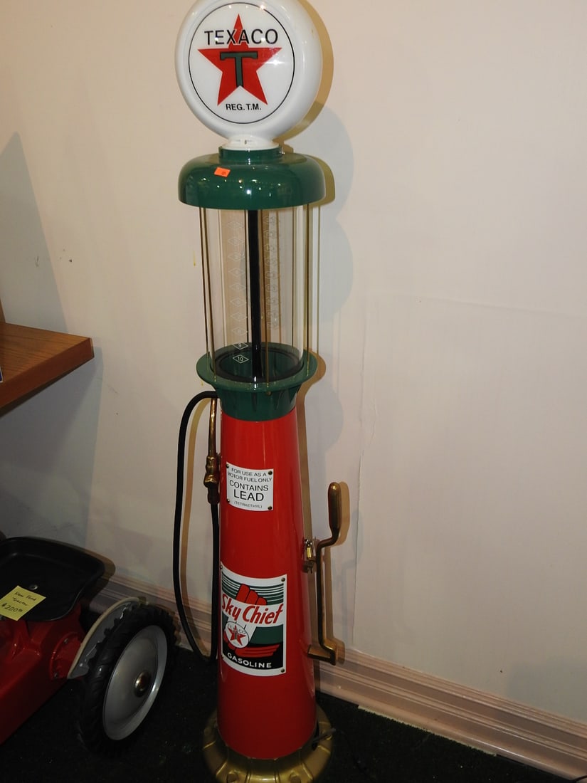 Texaco Sky Chief Gas Pump Reproduction: Tall decorative Texaco Sky Chief gas pump reproduction with red body, globe, hose/nozzle, brass-tone details, and Texaco/Sky Chief graphics. Originally part of a set and now being sold separately.