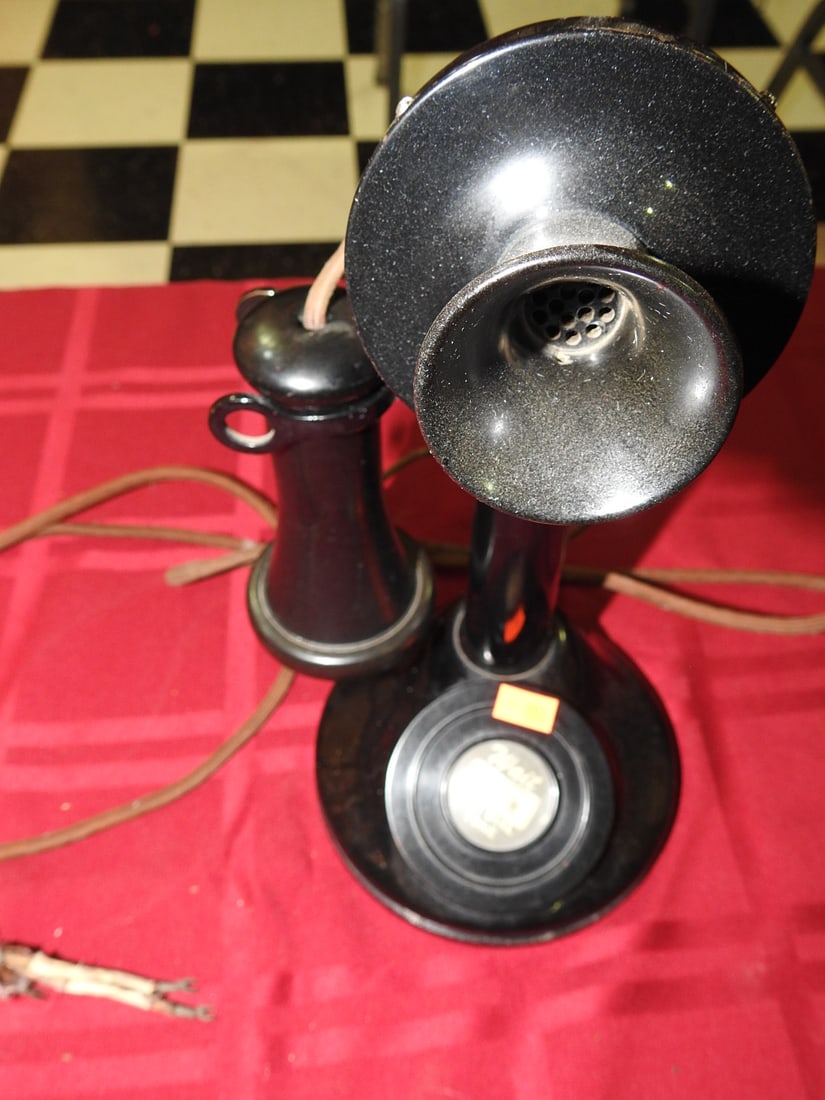 Black Candlestick Desk Telephone with Ford Tone Receiver: Antique black candlestick/desk telephone with separate receiver, cord, round base, and receiver cap marked “Ford Tone.” Includes worn paper note/label on base. Shows scuffs, wear, patina, and 