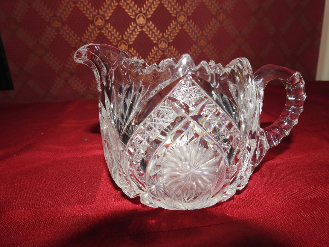 ABP Cut Crystal Creamer: American Brilliant Period style hand-cut crystal creamer with applied handle, scalloped rim and hobstar/fan cutting. Approx. 4 x 3.5 x 3.5 in. Unmarked unless otherwise noted; maker/pattern