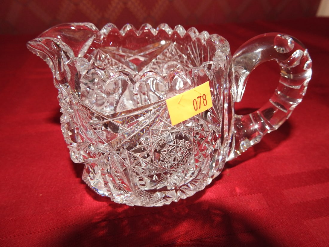 Cut Crystal Creamer: Vintage cut crystal creamer with applied handle and geometric cut decoration. Approx. 3 x 5.25 x 3 in. Unmarked unless otherwise noted; maker/pattern attribution is based on visible form, cuts and