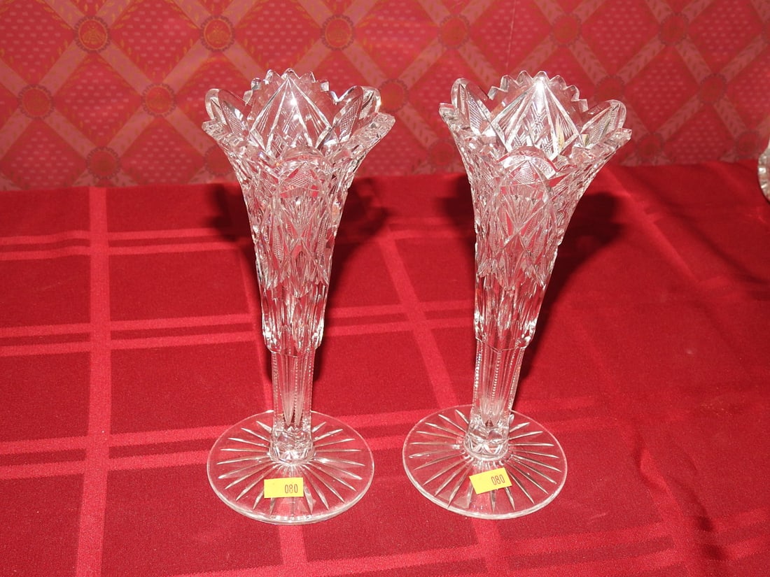 Pair Cut Crystal Bud Vases: Pair of vintage cut crystal bud vases with flared rims, faceted stems and star-cut bases. Approx. 8 x 3.25 x 3.25 in. Unmarked unless otherwise noted; maker/pattern attribution is based on visible