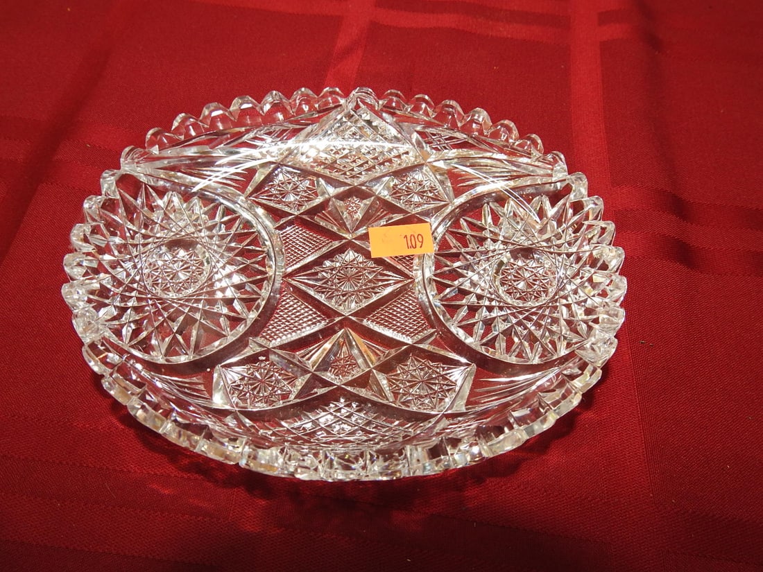 ABP Cut Glass Oval Nappy / Bonbon Dish: American Brilliant Period hand-cut glass oval nappy or bonbon dish with handle, hobstar/fan panels and scalloped rim. Approx. 3.25 x 6 x 5 in. Unmarked unless otherwise noted; maker/pattern