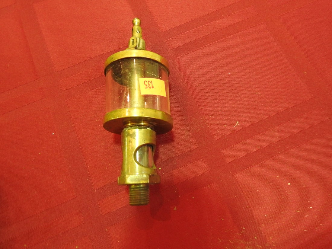 Essex Brass Co. Brass and Glass Cylinder Oiler: Antique brass and glass cylinder oiler marked Essex Brass Co. Approx. 5.5 x 1.75 x 1.75 in. Shows age-related wear, patina, finish wear, oxidation, surface scratches and handling wear consistent with