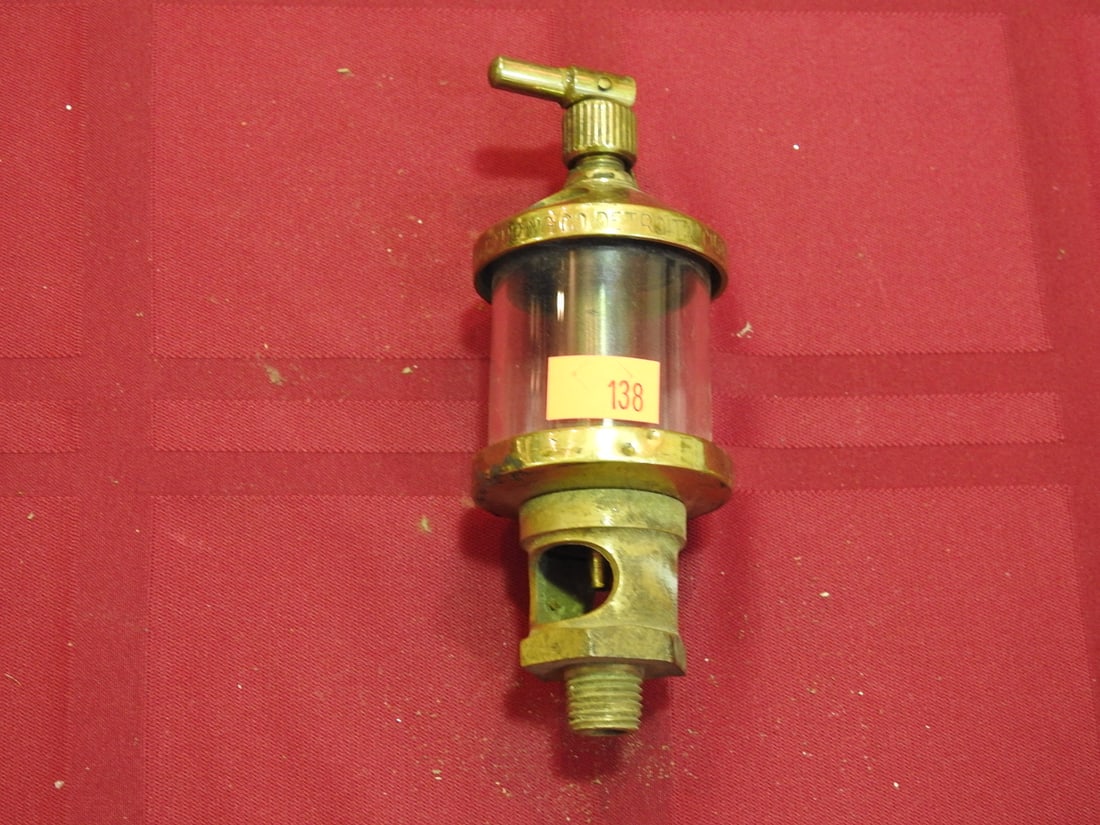 Lavigne Brass and Glass Cylinder Oiler: Antique brass and glass cylinder oiler marked Lavigne. Approx. 5 x 1.5 x 1.5 in. Shows age-related wear, patina, finish wear, oxidation, surface scratches and handling wear consistent with age and