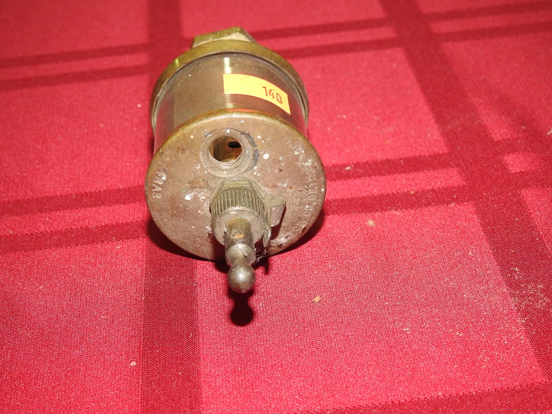 Michigan Lubricator Co. Cylinder Oiler: Antique brass and glass cylinder oiler marked Michigan Lubricator Co., Detroit. Approx. 5 x 2 x 2 in. Shows age-related wear, patina, finish wear, oxidation, surface scratches and handling wear consis