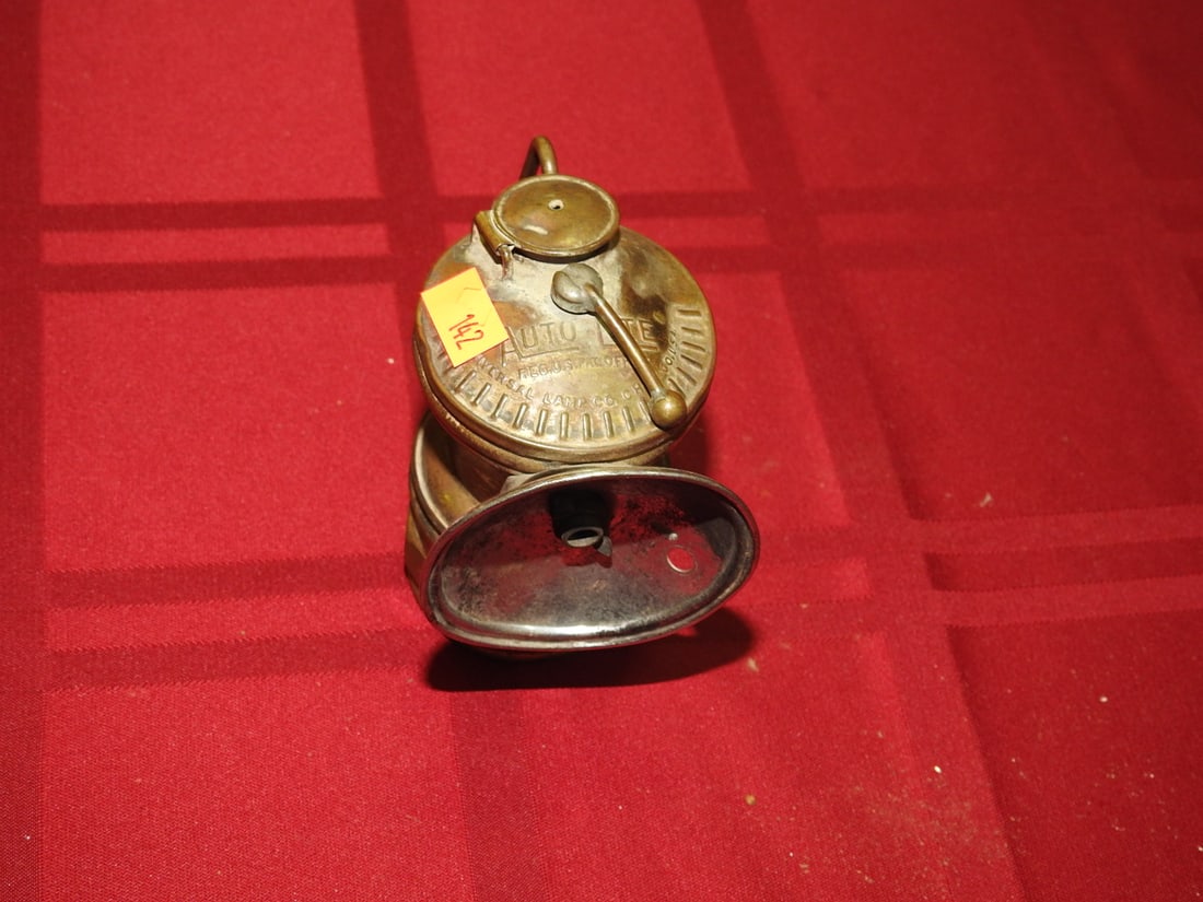 Auto-Lite Universal Carbide Miner Lamp: Vintage Auto-Lite Universal Lamp Co. brass carbide miner lamp. Approx. 3.75 x 2.5 x 2.25 in. No direct lot photos were included in the provided archives. Lighting function not tested. Shows age-relate