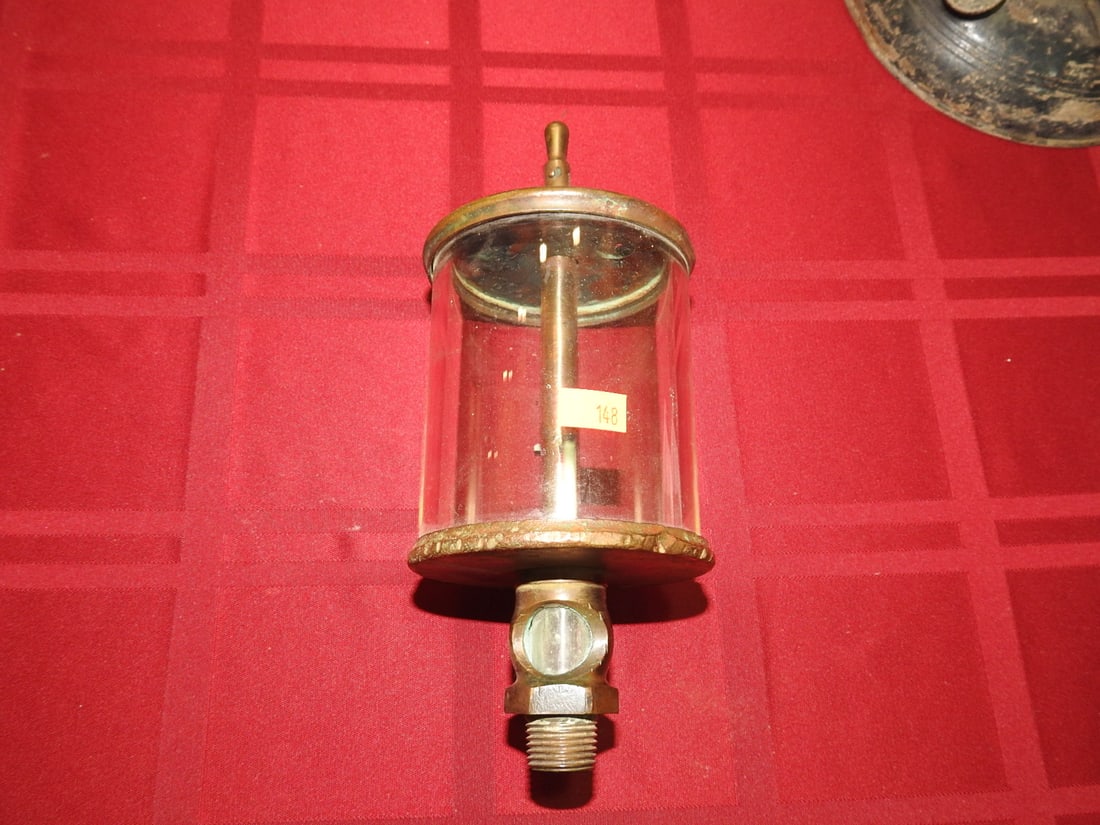 Lunkenheimer Brass and Glass Cylinder Oiler: Antique brass and glass cylinder oiler marked Lunkenheimer. Approx. 9 x 3.75 x 3.75 in. Shows age-related wear, patina, finish wear, oxidation, surface scratches and handling wear consistent with age
