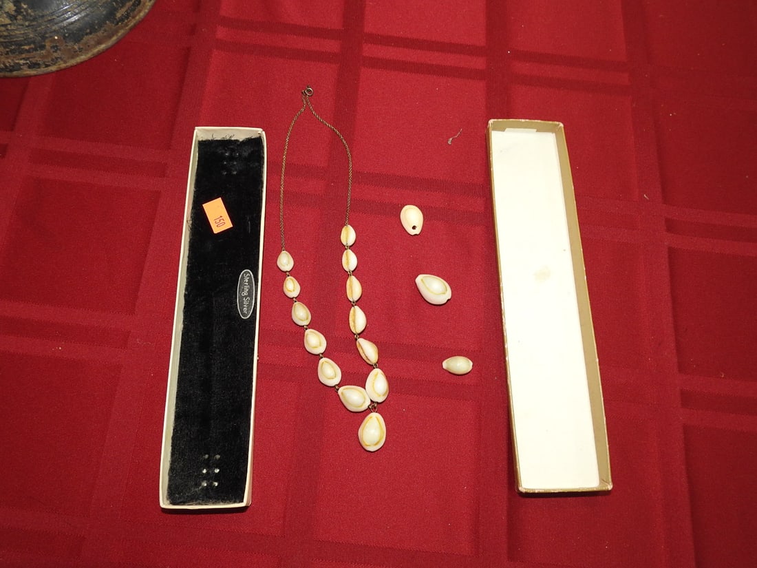 Hawaiian-Style Cowrie Shell Necklace: Vintage Hawaiian-style cowrie shell necklace with 13 shells on the chain plus 3 additional loose shells; chain is approximately 16 in. per notes. Approx. 8.5 x 2 x 2 in. Shows age-related wear,