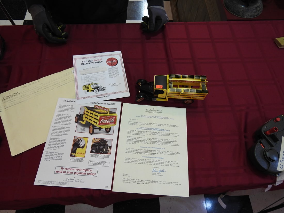 Danbury Mint 1927 Coca-Cola Delivery Truck Replica: Danbury Mint 1927 Coca-Cola delivery truck replica with title paperwork and box. Approx. 12 x 6 x 6 in. Shows age-related wear, patina, finish wear, oxidation, surface scratches and handling wear
