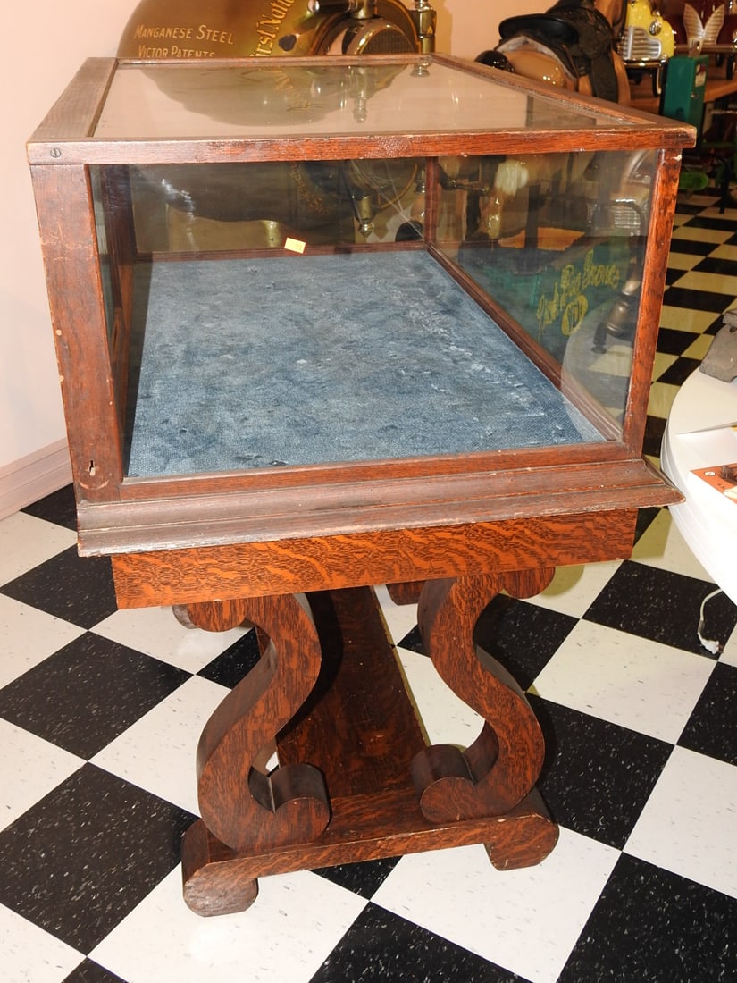 Lucky Mfg Co. Glass Display Case on Stand: Antique glass display case on wood/metal stand marked The Lucky Manufacturing Company, Portland, Oregon. Contents shown are not included. Approx. 46 x 45 x 27 in. Shows age-related wear, patina,