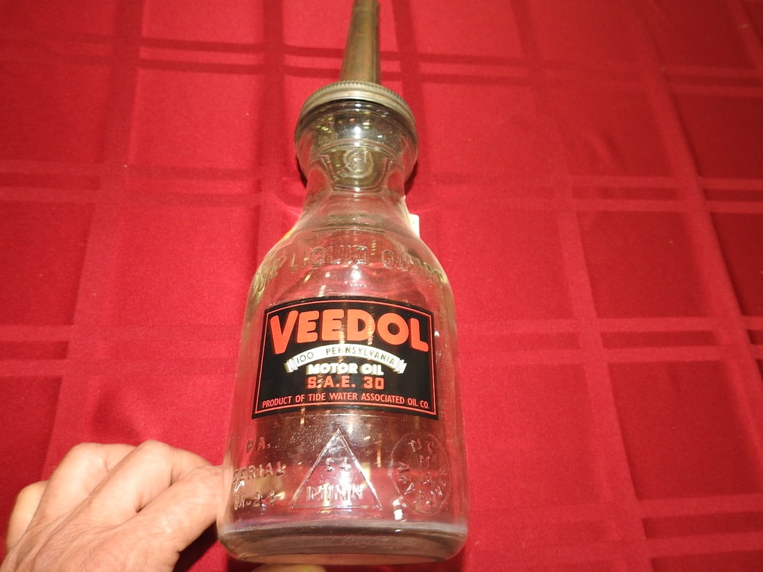 Veedol Motor Oil Glass Bottle with Spout: Antique quart glass oil bottle with Veedol Motor Oil label and metal spout. Approx. 13.5 x 3.75 x 3.75 in. Empty/decorative collectible; not tested for use. Shows age-related wear, patina, finish