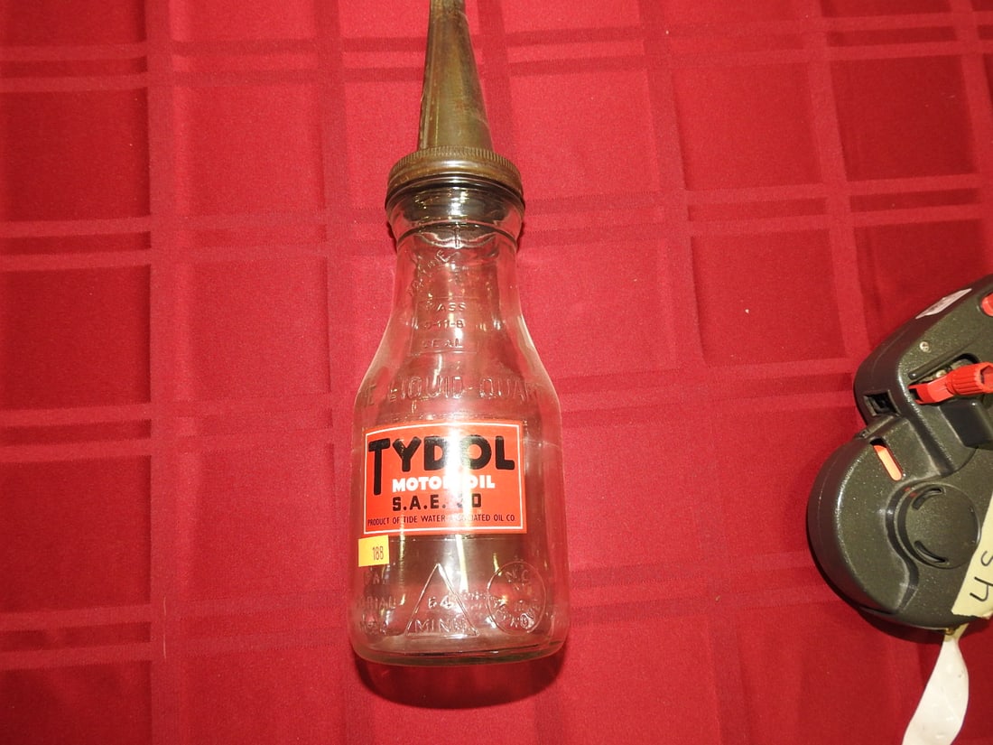 Tydol Motor Oil Glass Bottle with Spout: Antique quart glass oil bottle with Tydol label and metal spout. Approx. 13.5 x 3.75 x 3.75 in. Empty/decorative collectible; not tested for use. Shows age-related wear, patina, finish wear,