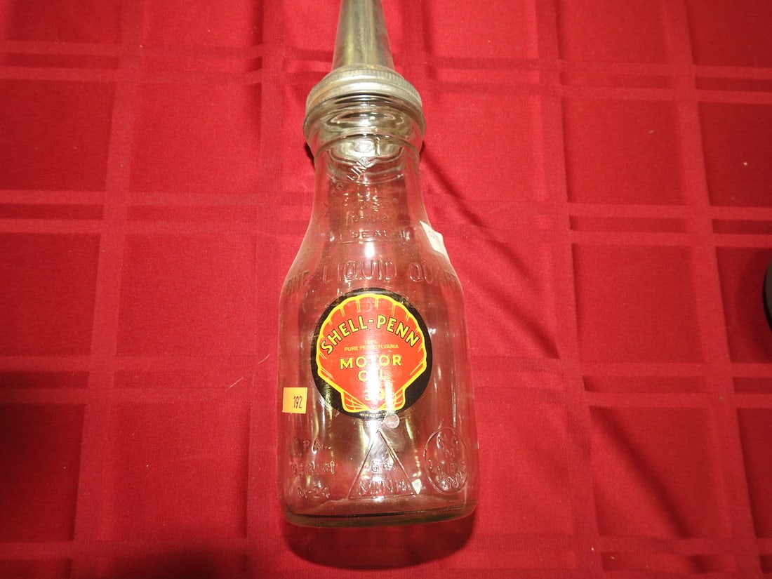 Shell Penn Motor Oil Glass Bottle with Spout: Antique quart glass oil bottle with Shell Penn Motor Oil label and metal spout. Approx. 13.5 x 3.75 x 3.75 in. Empty/decorative collectible; not tested for use. Shows age-related wear, patina, finish