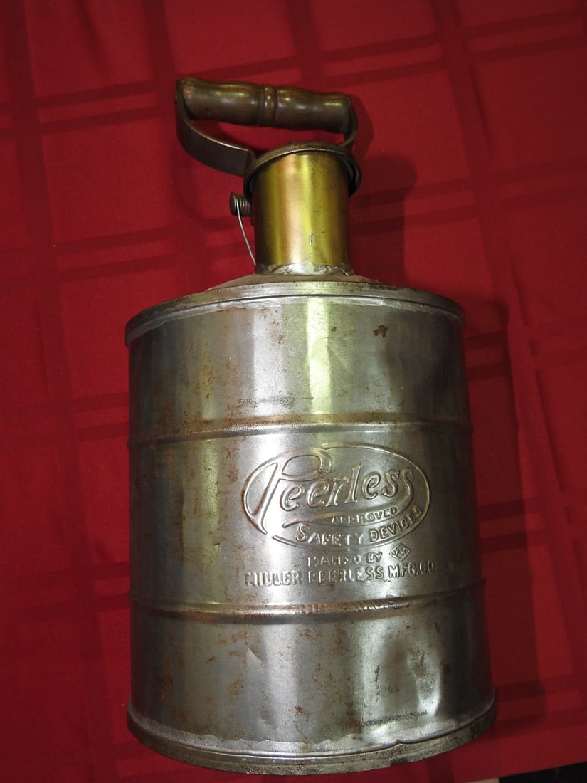 Peerless Metal Fuel Can, Chicago: Antique Peerless metal fuel can from Chicago with handle/spout assembly and worn metal finish. Approx. 14 x 6.5 x 6.5 in. Empty/decorative collectible; not tested for use. Shows age-related wear,