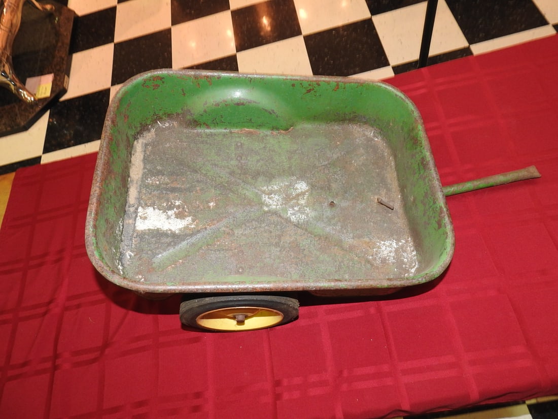 Vintage John Deere Metal Trailer: Vintage John Deere metal trailer with green bed, yellow wheels and pull handle. Approx. 9 x 15 x 27.5 in. Hitch appears broken per notes. Shows paint wear, oxidation, surface rust, scratches and
