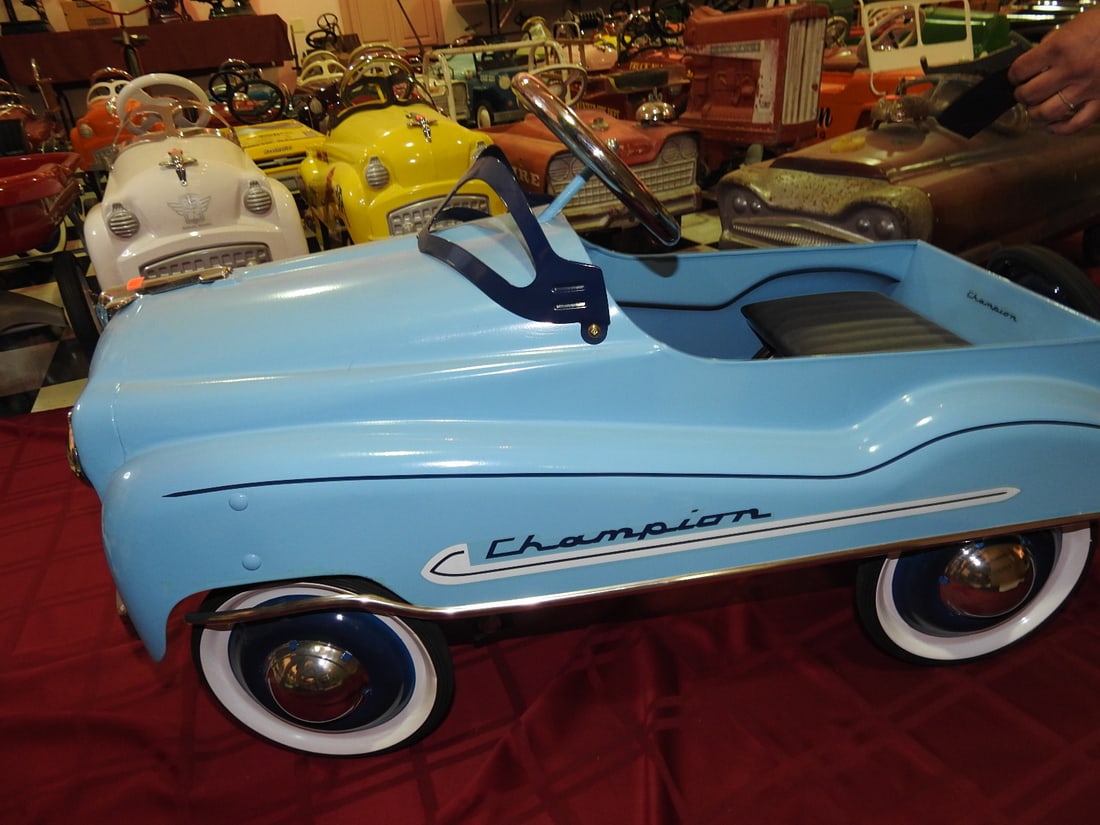 Limited Edition Champion Pedal Car: Limited edition Champion pedal car with light blue body and chrome-style grille/trim. Approx. 22 x 17 x 37 in. Shows light display wear, scuffs and handling wear; see photos for condition details.