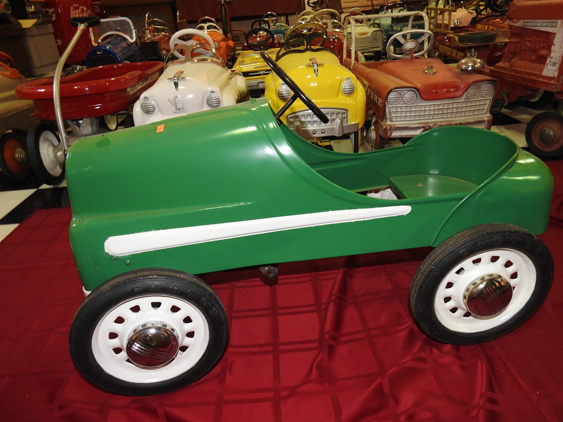 Green Classic Metal Pedal Car: Classic metal pedal car in green with open cockpit, black seat and white wheels. Approx. 21 x 20 x 35 in. Shows display/use wear, surface scratches, scuffs and handling wear; see photos for condition