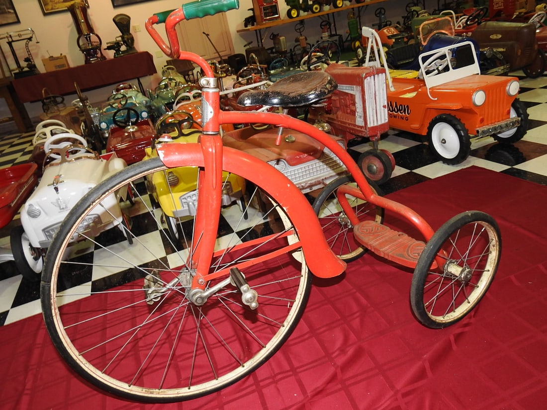 1939 Werlich Canadian Tricycle: Vintage 1939 Werlich tricycle made in Canada, red with large front wheel and patinated finish. Approx. 34 x 20 x 44 in. Shows paint wear, oxidation, wheel/tire wear, scratches and age-related use