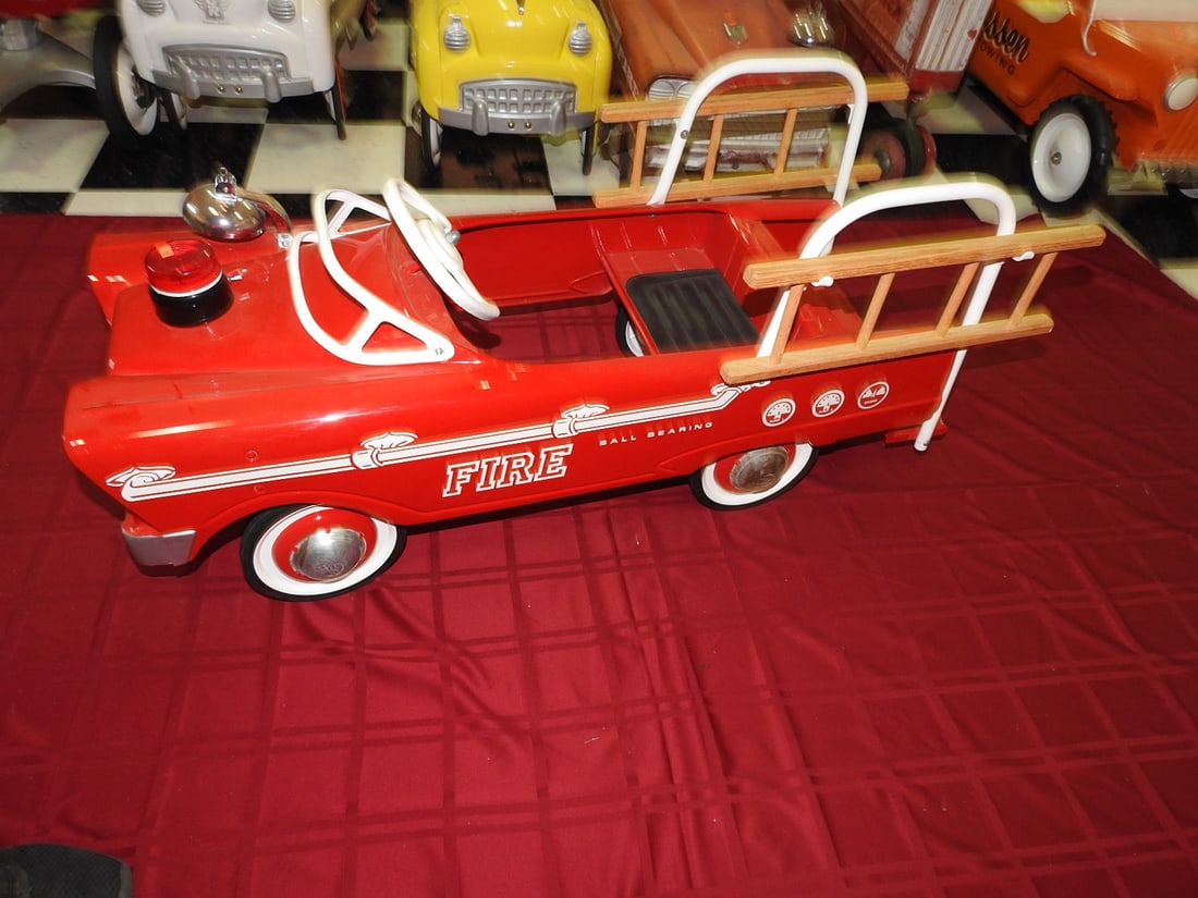 Limited Edition Fire Chief No. 5 Pedal Car: Limited edition Fire Chief No. 5 pedal car with red body, ladders, white steering wheel and ball-bearing style wheels noted on card. Approx. 20 x 17 x 43 in. Shows display/use wear, small scuffs, surf