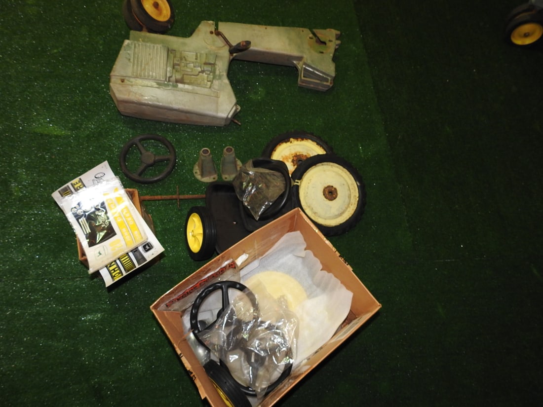 John Deere Model 520 Pedal Tractor Restoration Project: Vintage John Deere Model 520 pedal tractor restoration project with restoration kit, decals/stickers and parts shown. Approx. 24 x 22 x 36 in. Appears to include parts for restoration; sold as a