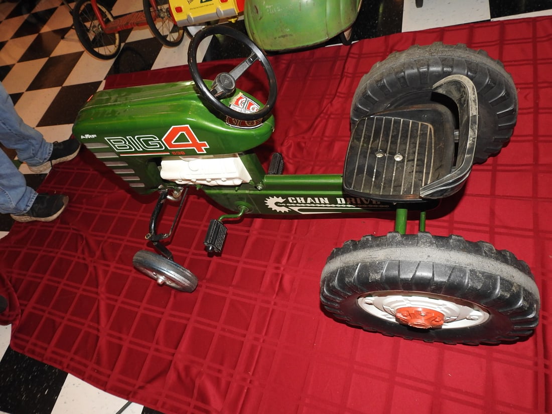 AMF Big 4 Pedal Tractor: AMF Big 4 pedal tractor with metal body, steering wheel, seat and pedal drive. Approx. 24 x 27 x 37 in. Shows age/use wear, paint loss, scratches, oxidation, tire wear and patina; see photos for condi