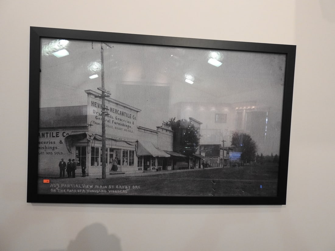 Framed Road of a Thousand Wonders Canby OR Main St Photo: Framed black-and-white historical photograph/print, No. 9 partial view of Main Street, Canby, Oregon, from The Road of a Thousand Wonders series. Approx. 24 x 38 x 1 in. Frame and print show