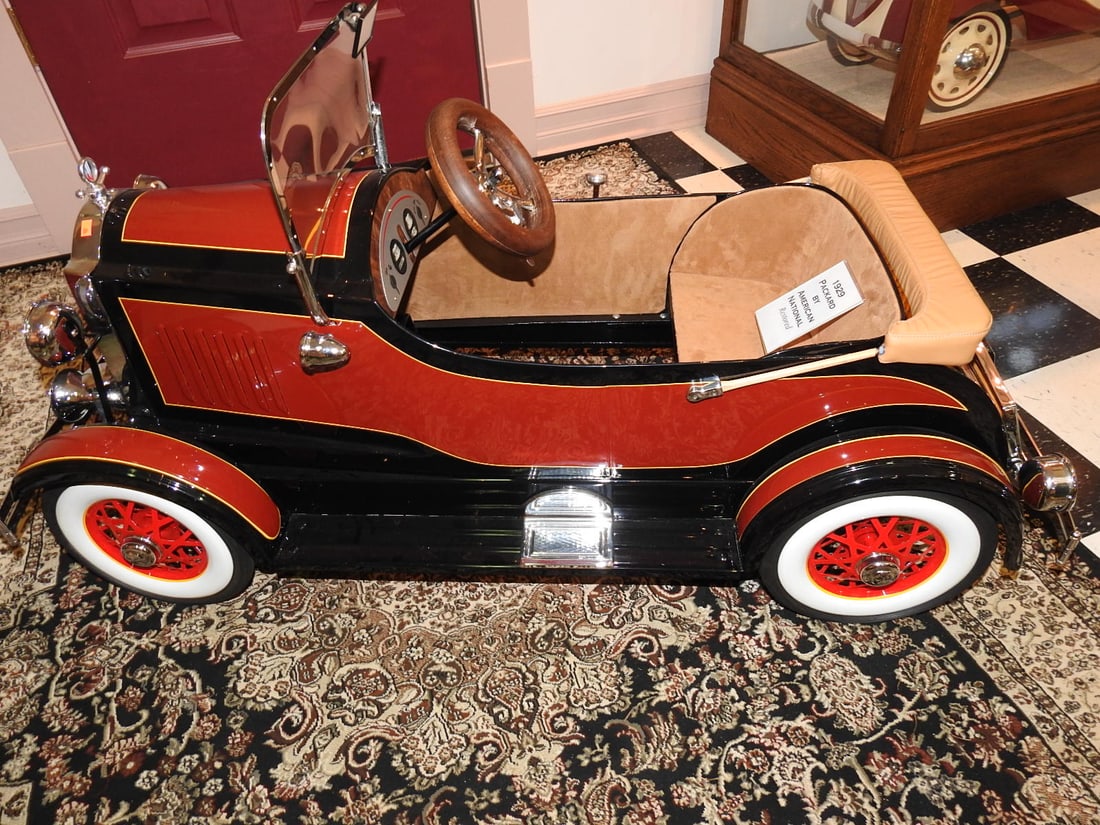 Restored 1929 Packard American National Pedal Car: Restored 1929 Packard American National pedal car with cream and red finish, chrome-style trim, windshield, steering wheel and whitewall-style tires. Approx. 26 x 21 x 52 in. Consignor notes indicate