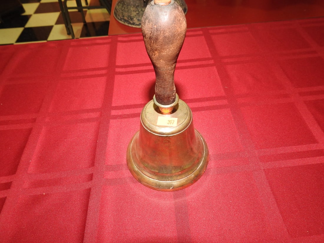 Antique Brass Bell with Wooden Handle: Antique brass hand bell with turned wooden handle. Approx. 8 x 4.5 x 4.5 in. Shows age/use wear, patina, tarnish, scratches, dents and wood wear; see photos for condition details.