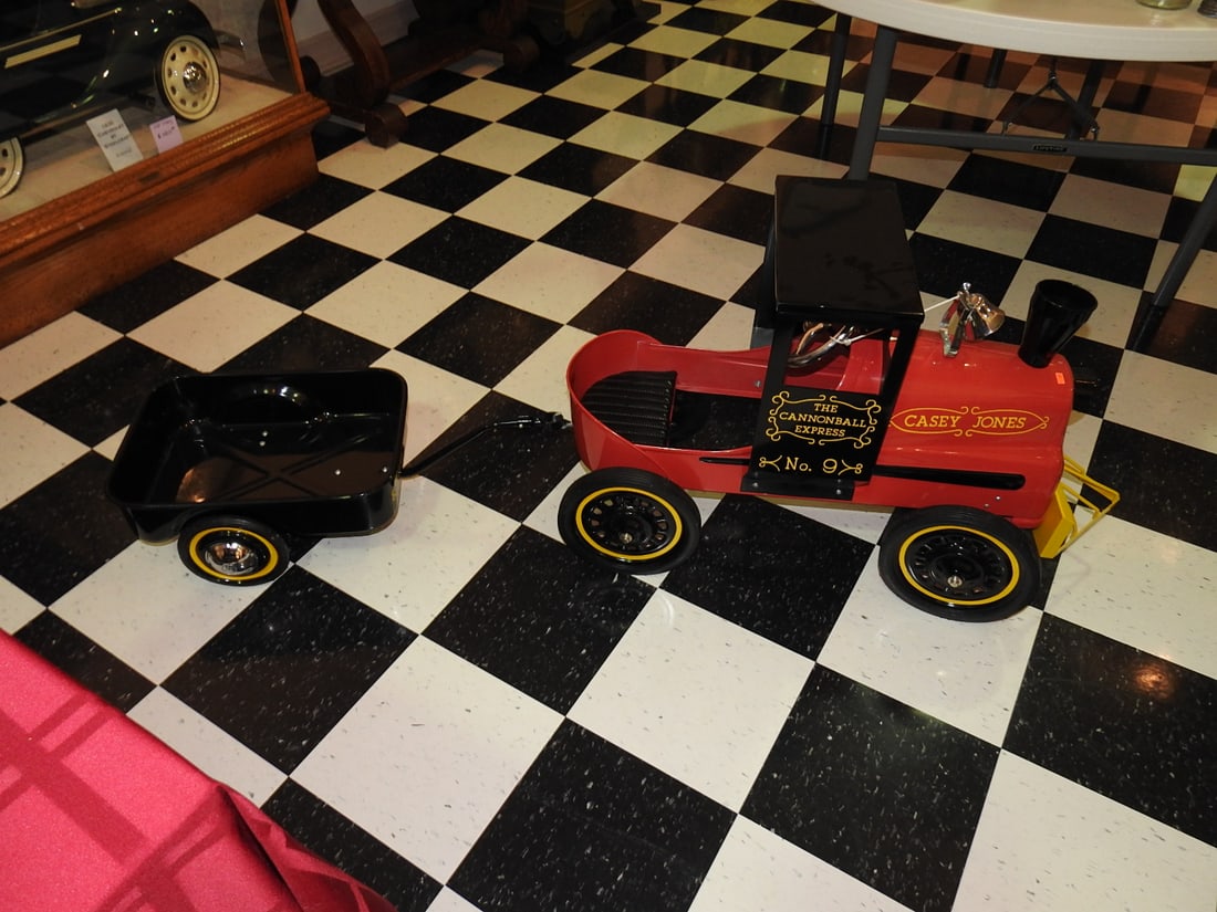 New Casey Jones Cannon Ball Express Pedal Train with Trailer: Casey Jones No. 9 Cannon Ball Express pedal train car with matching trailer, noted as new. Approx. 30 x 20 x 43 in. New/unused or reproduction status is per lot notes. Shows light display/handling