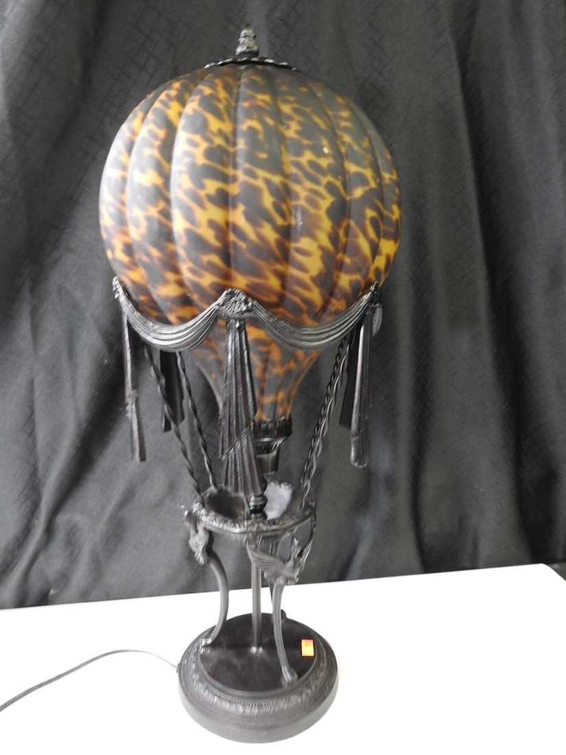 Hot Air Balloon Style Table Lamp: Decorative hot air balloon style lamp with cast metal base and globe shade. Approx. 25 H x 12 W x 12 D in.