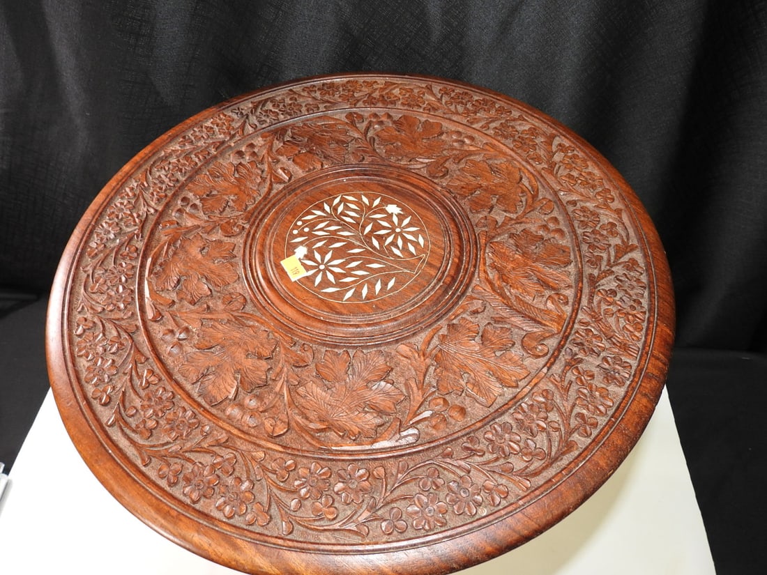 Antique Hand-Carved Folding Table with Inlay: Antique decorative folding table, likely oak, with hand-carved floral design and marquetry/inlay-style decoration. Approx. 18 H x 18 W x 18 D in.