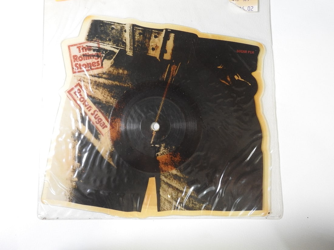 Rolling Stones Brown Sugar Pants Shaped Picture Disc: Collectible 1984 Pants shaped picture disc of The Rolling Stones Brown Sugar featuring Andy Warhol jeans imagery. Original price tag present. Approx. 0.5 H x 10.5 W x 10 D in.