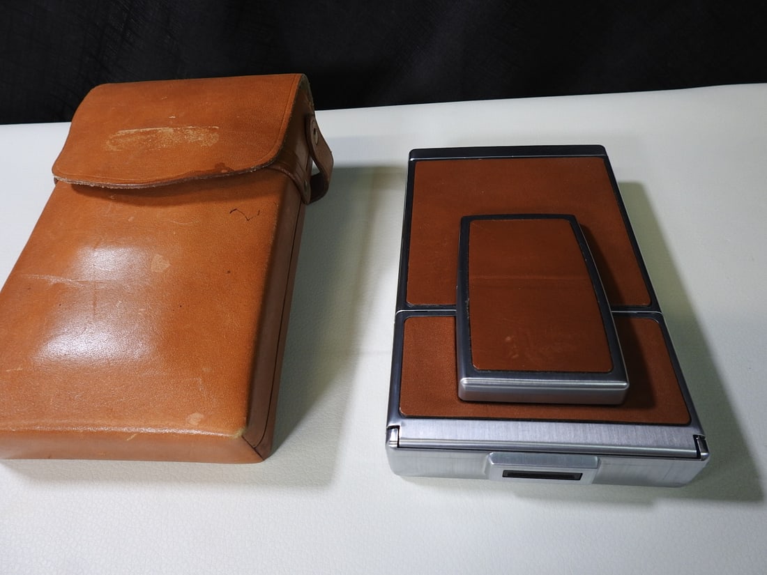 Polaroid SX-70 Instant Land Camera with Leather Case: Polaroid SX-70 folding instant land camera with iconic tan leather case. Approx. 2.5 H x 4.5 W x 7.5 D in.