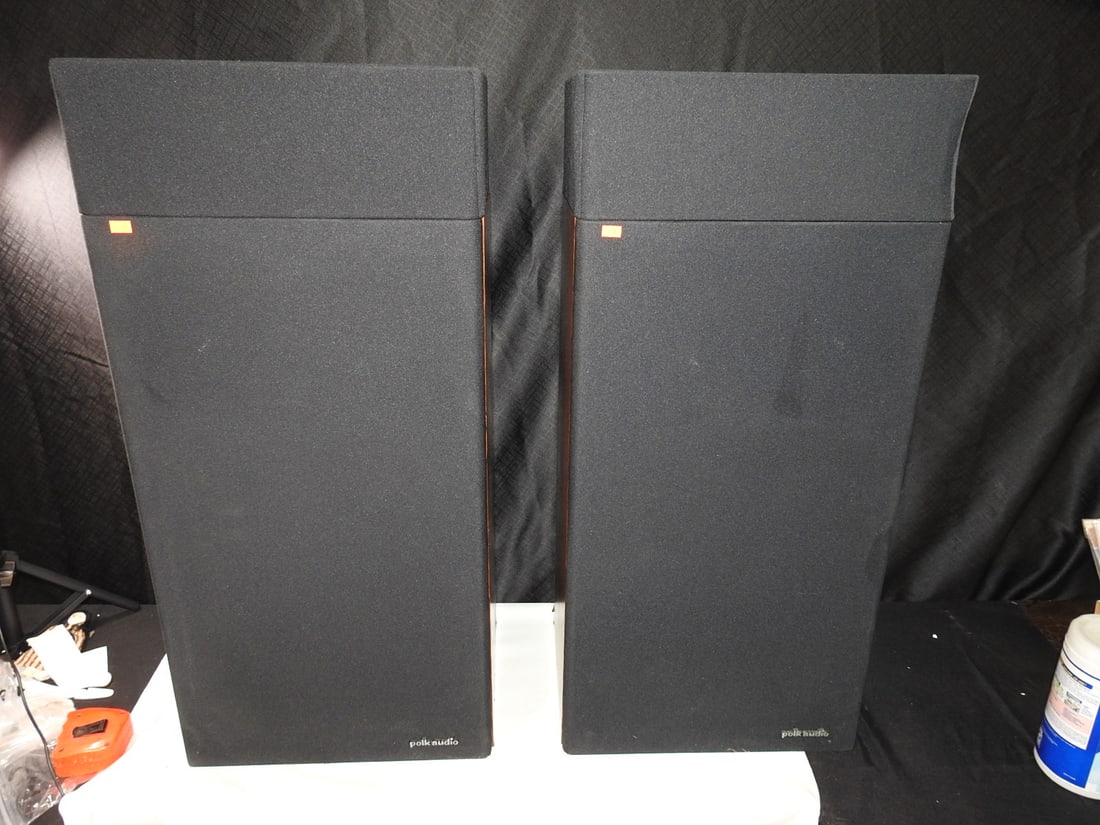 Polk Audio RTA-12 Floor Speakers Pair: Pair of vintage Polk Audio RTA-12 floor speakers with woodgrain cabinets, black grilles, rear serial numbers 12-01969 and 12-01983, and top-mounted exposed tweeter/crossover assemblies. Each cabinet