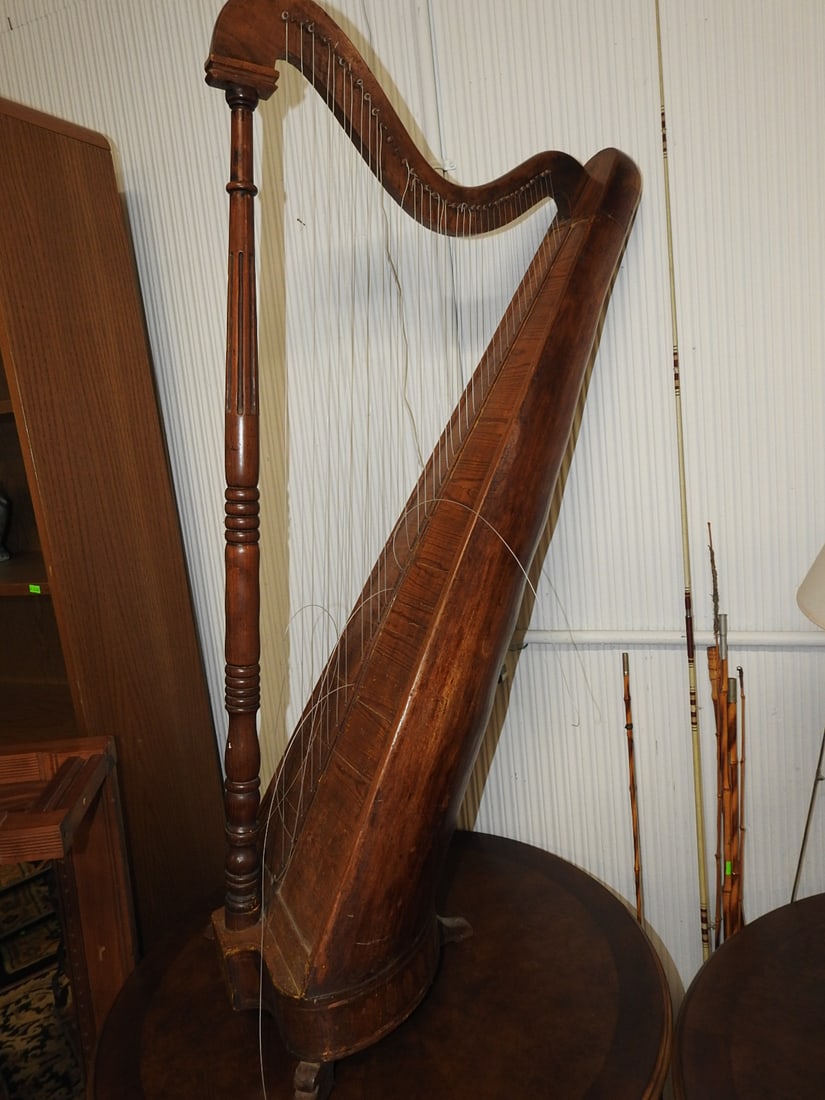 Antique Wooden Harp: Antique wooden harp with carved column and curved neck. Needs tuning/servicing. Approx. 53 H x 25 W x 28 D in.