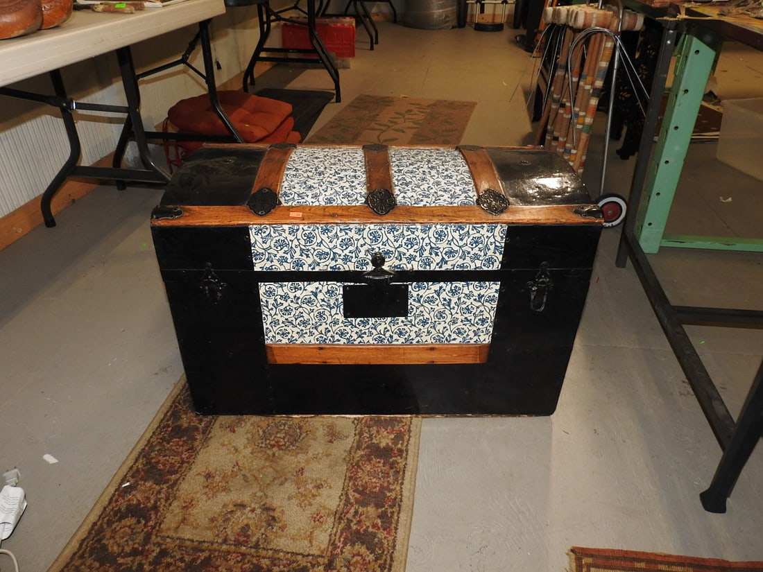 Decorative Antique Steamer Trunk: Decorative antique steamer trunk with wood slats, black body, patterned panels, metal hardware, and interior lithograph label. Approx. 20 H x 30 W x 16 D in.