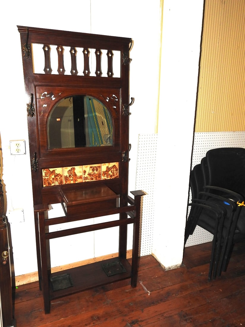 Antique Hall Tree with Mirror & Ceramic Tile Panels: Antique wood hall tree with mirror, coat hooks, umbrella/cane stand area, lift-top storage box, and four decorative ceramic tiles showing a rustic European village/farmhouse scene. No maker's mark fou