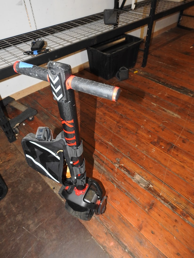 Kiwano KO1+ Carbon Fiber One-Wheel Electric Scooter: Kiwano KO1+ self-balancing one-wheel electric scooter with carbon-fiber style body, handlebar control section, foot platforms, and charger. Tested and powers on. Approx. 44 x 12 x 9 in.