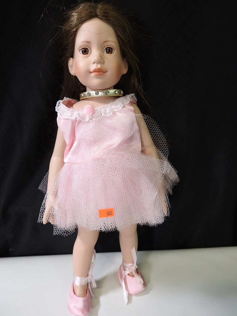 17 in. American Girl Doll in Pink Dress: Doll in pink dress with painted features and long hair. Head is loose but remains attached. Approx. 17 H x 7 W x 4 D in.