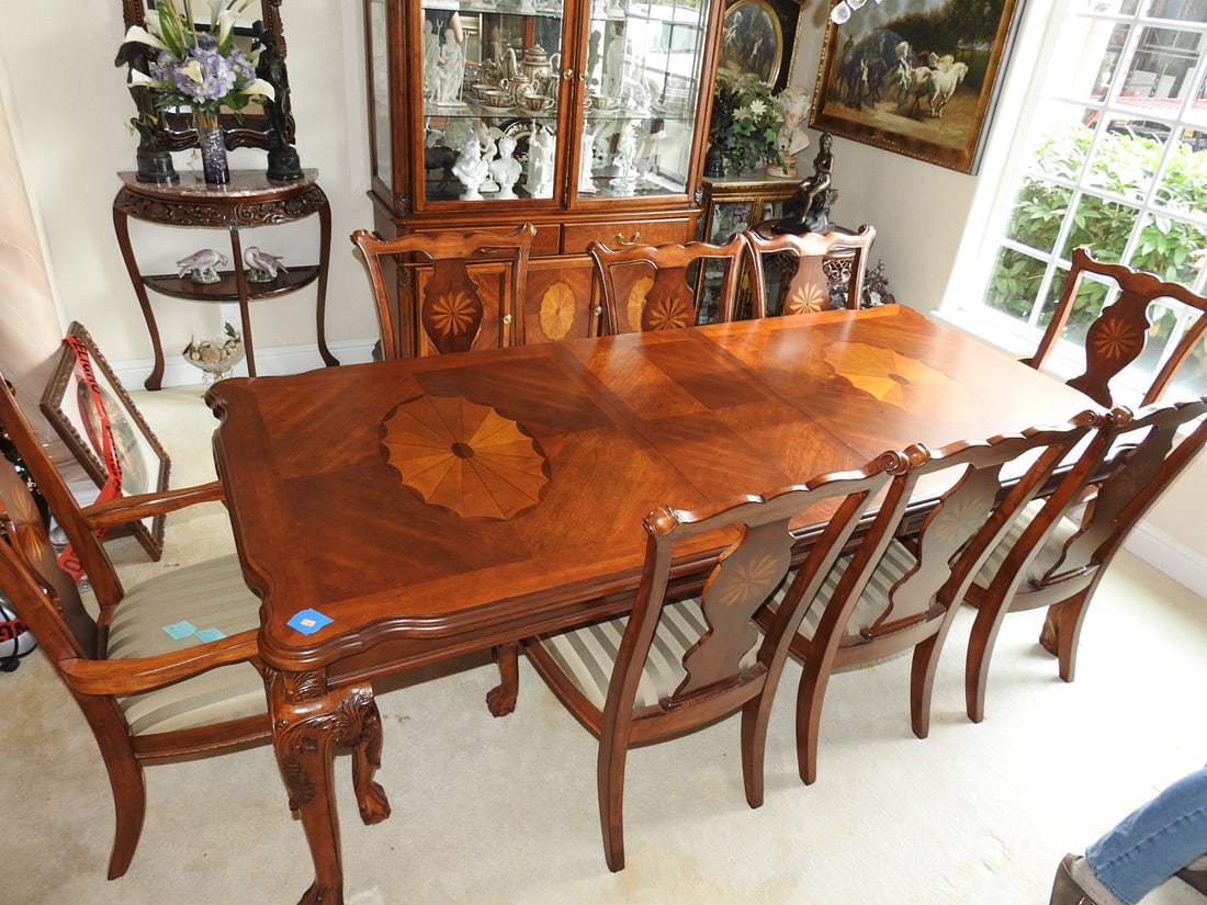 Vintage Baroque Style Dining Table with 10 Chairs: Vintage Baroque style dining table set with ten matching chairs. Features carved legs, carved apron/girdle detail, ball-and-claw style feet, and starburst inlay design on the tabletop and chair