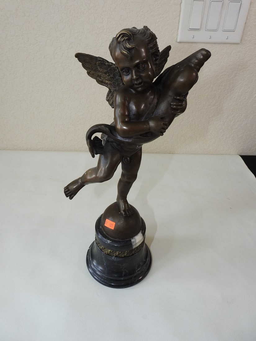 Bronze Cherub with Fish Statue after Andrea del Verrocchio: Bronze cherub with fish figural statue after Andrea del Verrocchio. Mounted on a black marble base. Approx. 16 x 7 x 6 in.