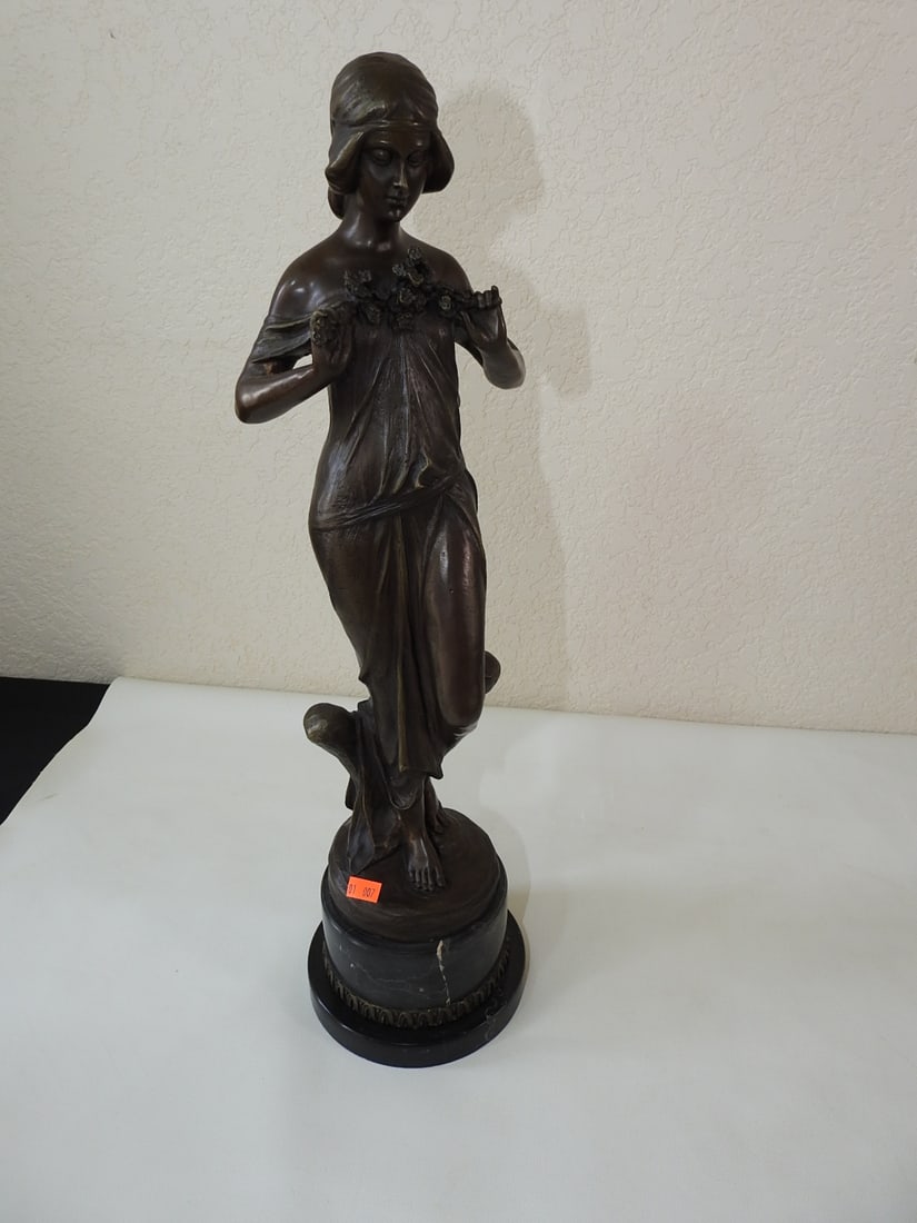 Bronze Spirit of Spring Statue after Jean Patoue: Solid bronze Spirit of Spring statue after Jean Patoue, mounted on a black marble base. Approx. 20.5 x 5.75 x 5.75 in.