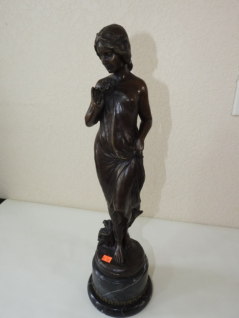 Bronze Allegory of Spring Statue after Jean Patoue: Solid bronze Allegory of Spring statue after Jean Patoue, mounted on a black marble base. Approx. 20.5 x 5.5 x 5.5 in.