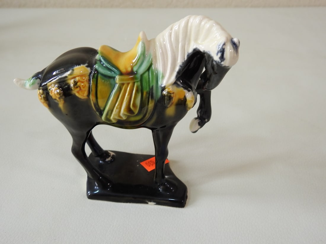 Majolica Style Black Tang Horse Figurine: Ceramic Majolica style Tang Dynasty horse figurine in black with green, white, and yellow accents. Approx. 5 x 4.5 x 1.75 in.