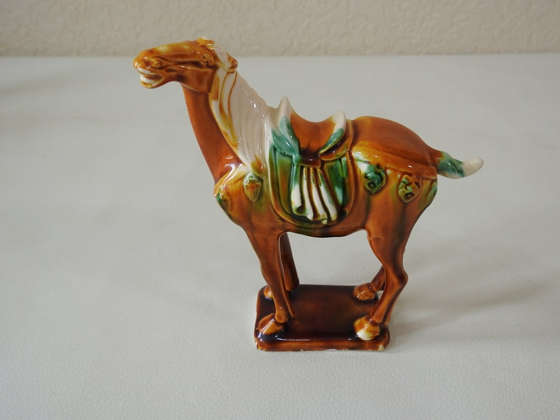 Majolica Style Tan Tang Horse Figurine: Ceramic Majolica style Tang Dynasty horse figurine in tan with white, yellow, blue, and green accents. Approx. 5.5 x 5.5 x 1.75 in.