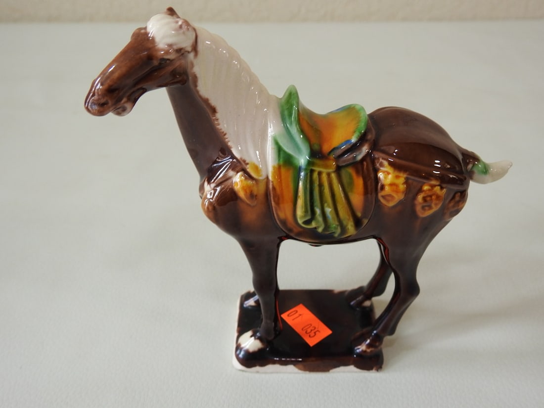 Majolica Style Brown Tang Horse Figurine: Ceramic Majolica style Tang Dynasty horse figurine in brown with white, yellow, blue, and green accents. Approx. 4.25 x 4 x 2.5 in.