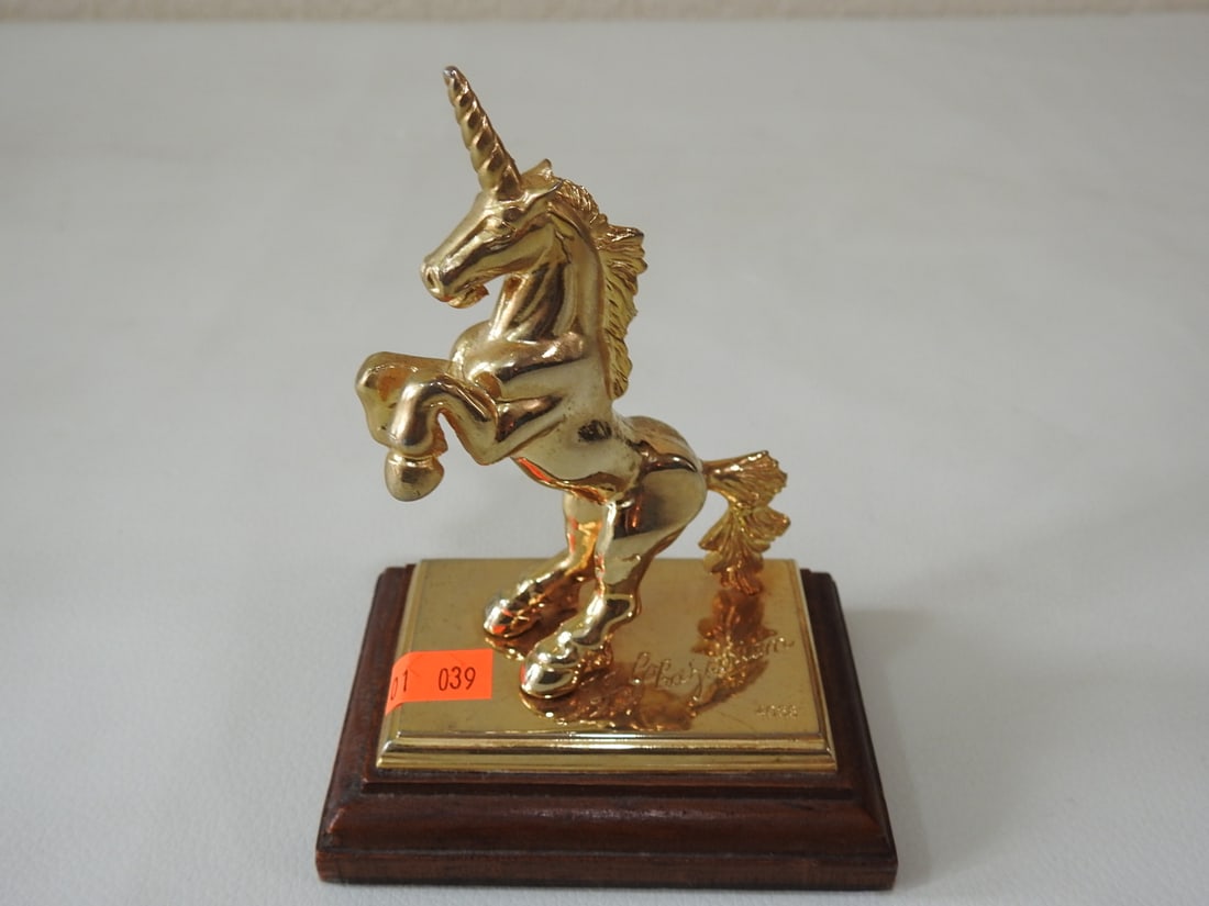 H. Ghazarian 1983 Gold-Plated Unicorn Figurine: Gold-plated rearing unicorn figurine on pewter base metal with wood display base, marked H. Ghazarian 1983. Approx. 5.25 x 3.75 x 2.75 in.