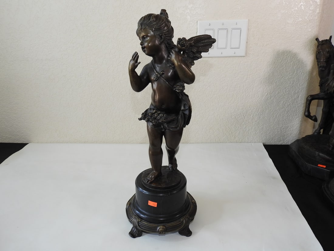 E. Platy Bronze Cherub Statue on Marble Base: Bronze cherub statue marked/noted E. Platy, mounted on black marble base. Approx. 20 x 9 x 9 in.