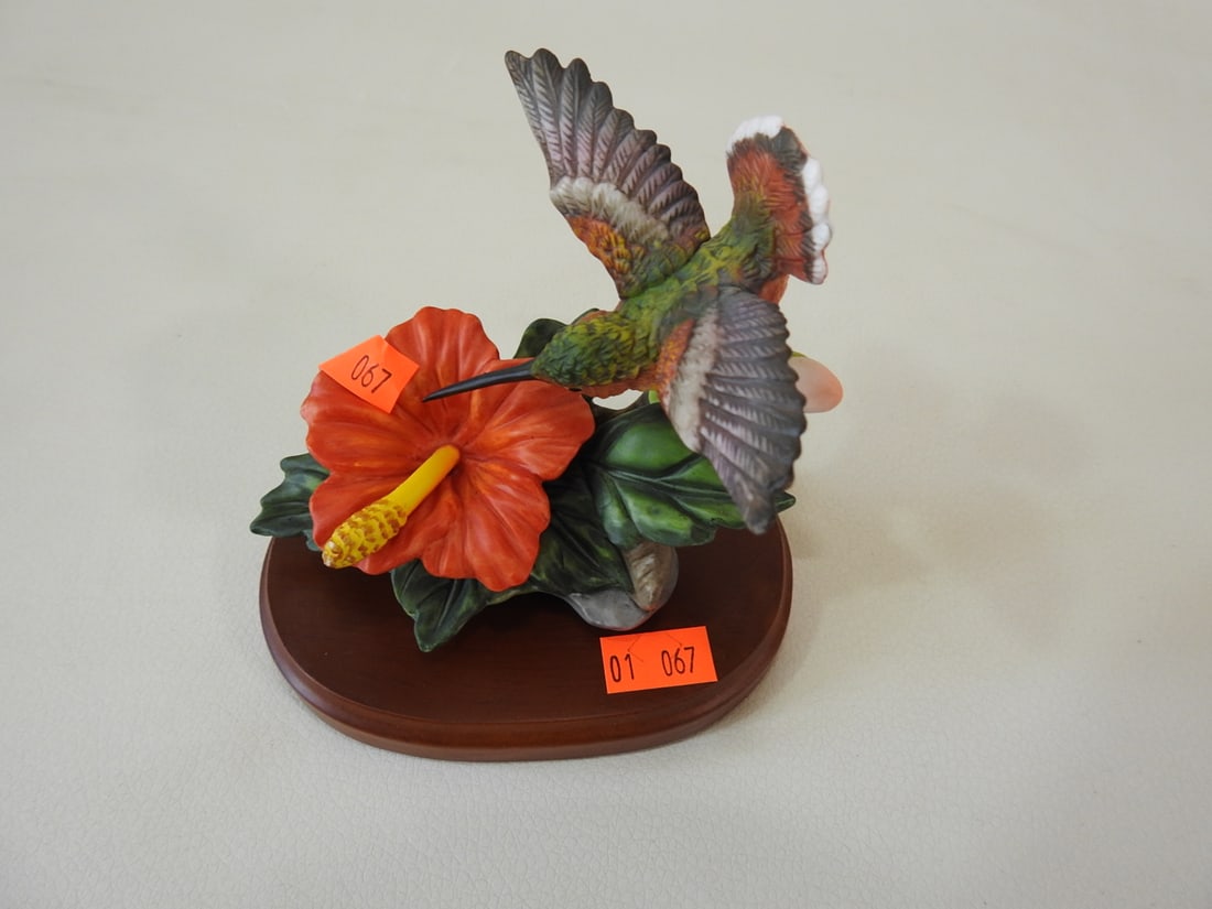 Vintage Porcelain Bisque Hummingbird with Hibiscus: Vintage hand-painted ceramic/porcelain bisque hummingbird figurine hovering over a hibiscus flower on wood base. Approx. 4 x 4 x 3.5 in.